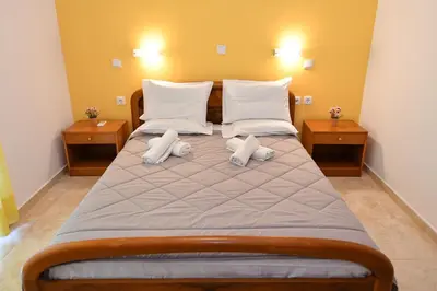 a bedroom with a large bed with two pillows at Blue Serenity Apartment 5 in Ialyssos