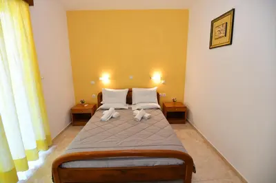 a bedroom with a bed with two towels on it at Blue Serenity Apartment 5 in Ialyssos