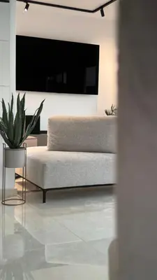a living room with a couch and a tv at ARYVE Boutique Villa mit Akropolis- und Meerblick, Infinity-Pool und Designer-Interieur in Malona Village
