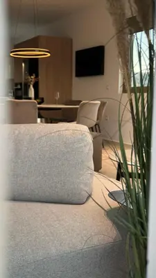 a living room with a couch and a table and chairs at ARYVE Boutique Villa mit Akropolis- und Meerblick, Infinity-Pool und Designer-Interieur in Malona Village