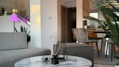 a living room with a couch and a table at ARYVE Boutique Villa mit Akropolis- und Meerblick, Infinity-Pool und Designer-Interieur in Malona Village
