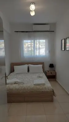 a bedroom with a bed with two towels on it at George & Chrysi Apart in Kremasti