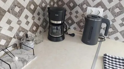 a coffeemaker and a coffee maker on a counter at George & Chrysi Apart in Kremasti