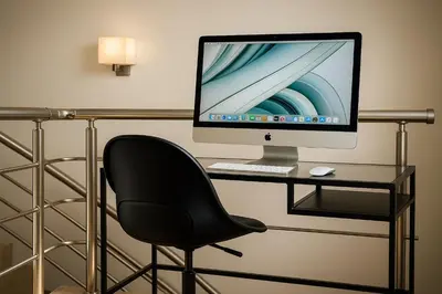 a desk with a computer monitor and a chair at Villa Solmar Rhodes in Lachania