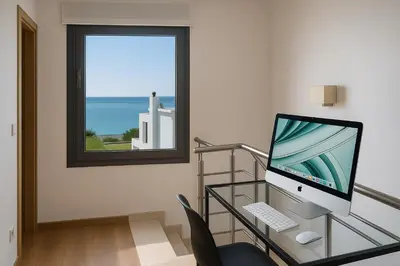 a computer sitting on a glass desk with a window at Villa Solmar Rhodes in Lachania