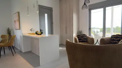 a kitchen and living room with chairs and a counter at ARYVE Townhouse Rhodos mit Akropolis- und Meerblick sowie Jacuzzi und tollen Sonnenterrassen und Garten in Malona Village