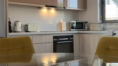 a kitchen with a table and a microwave oven at ARYVE Townhouse Rhodos mit Akropolis- und Meerblick sowie Jacuzzi und tollen Sonnenterrassen und Garten in Malona Village