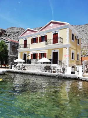 a house on the side of a body of water at Perla di Mare - Katoi 1 in Symi