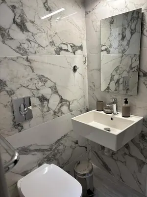 a white bathroom with a sink and a toilet at Kyra Maria 2, view Apartment in Rhodes Town