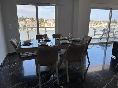 a dining room with a table and chairs with a view at Kyra Maria 2, view Apartment in Rhodes Town