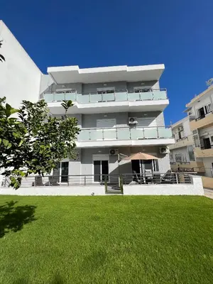 a large building with a lawn in front of it at Kyra Maria 2, view Apartment in Rhodes Town