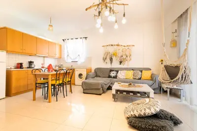 a living room with a couch and a table at Sunset View in Rhodes Town