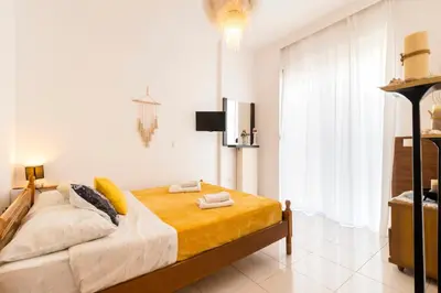 a bedroom with a bed and a television in it at Sunset View in Rhodes Town