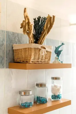 a shelf with three glass jars and a basket at Sunset View in Rhodes Town