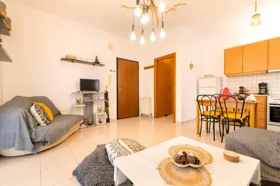 a living room with a couch and a table at Sunset View in Rhodes Town