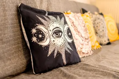 a pillow with an owl on a couch at Sunset View in Rhodes Town