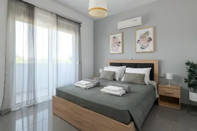 a bedroom with a bed with two towels on it at Niovis Villa in Pastida