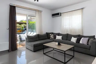 a living room with a couch and a table at Niovis Villa in Pastida