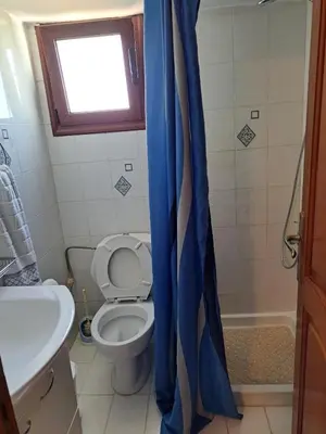 a bathroom with a toilet and a shower curtain at Terrace Studio in Rhodes Town