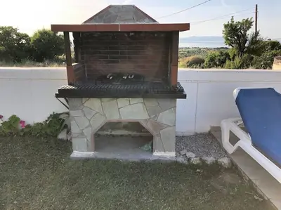 a brick oven sitting on top of a yard at Welcome to relaxation in Phanaes