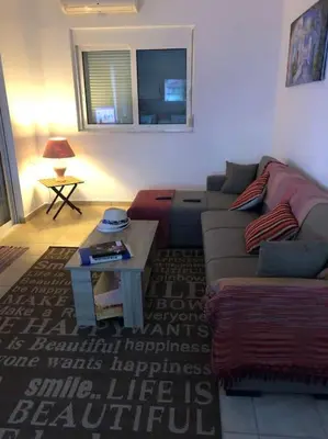 a living room with a couch and a coffee table at Welcome to relaxation in Phanaes
