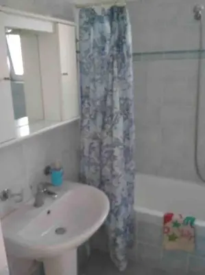 a bathroom with a sink and a shower curtain at Welcome to relaxation in Phanaes