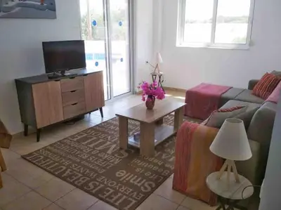 a living room with a couch and a tv at Welcome to relaxation in Phanaes