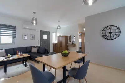 a living room with a blue couch and a table at Louka's House in Afantou