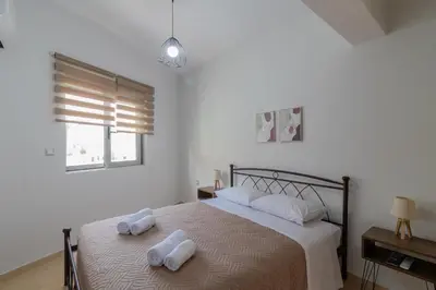 a bedroom with a bed with towels on it at Louka's House in Afantou