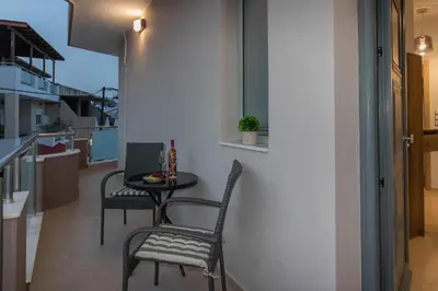 a small table and two chairs in a kitchen at Louka's House in Afantou