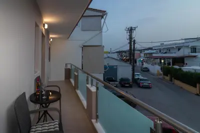 a balcony with a table and a view of a street at Louka's House in Afantou