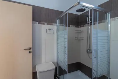 a bathroom with a shower and a toilet at Louka's House in Afantou