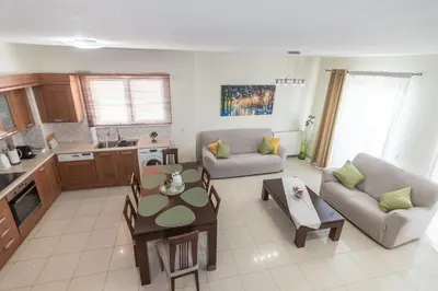 a living room with a couch and a table at Rhodes Views in Rhodes Town
