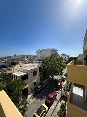 a view of a city with cars parked in a parking lot at Rhodes Views in Rhodes Town