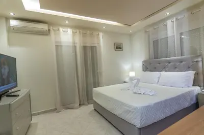 a bedroom with a bed and a television at Rhodes Views in Rhodes Town