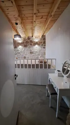 a bathroom with a white desk and a mirror at Nisyros Nest in Nikiá
