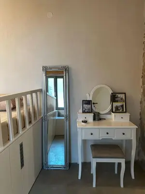 a dressing room with a mirror and a dressing table at Nisyros Nest in Nikiá