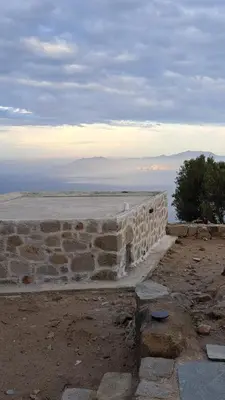 a stone wall with the ocean in the background at Nisyros Nest in Nikiá