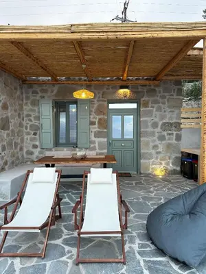 a patio with two chairs and a table and a couch at Nisyros Nest in Nikiá