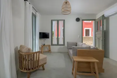 a living room with a couch and a chair at Onar Residences Chalki in Halki