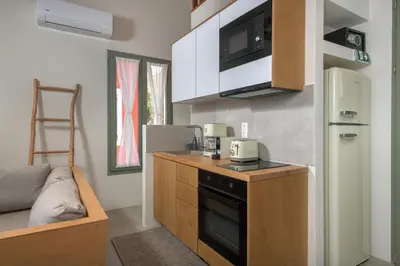 a small kitchen with a stove and a refrigerator at Onar Residences Chalki in Halki