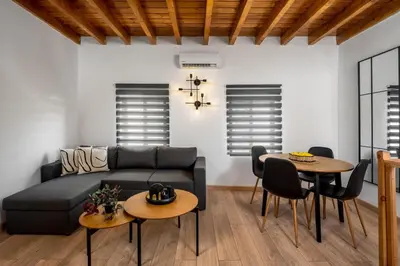 a living room with a couch and two tables at D'Amboise House in Rhodes Town