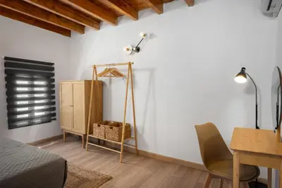 a bedroom with a bed and a desk and a lamp at D'Amboise House in Rhodes Town