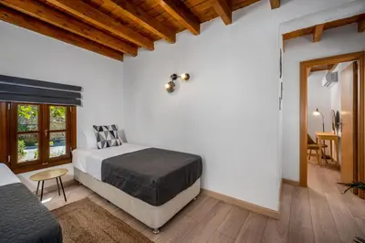 a bedroom with a bed and a table and a window at D'Amboise House in Rhodes Town