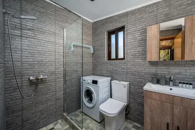 a bathroom with a washing machine and a sink at D'Amboise House in Rhodes Town