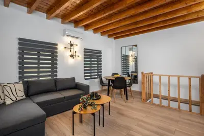 a living room with a couch and a table at D'Amboise House in Rhodes Town