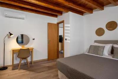 a bedroom with a bed and a desk with a chair at D'Amboise House in Rhodes Town