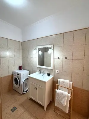 a bathroom with a washing machine and a sink at Cullura in Asklipiḯon