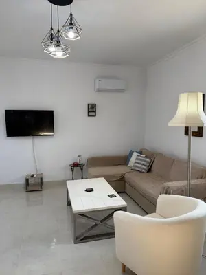 a living room with a couch and a table at Cullura in Asklipiḯon