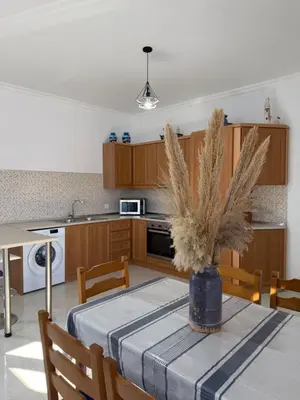 a kitchen with a table with a vase on it at Cullura in Asklipiḯon